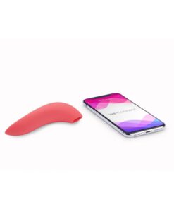 Pink We-Vibe Melt bluetooth and app controlledÂ air pulse and suction vibrator sitting next to a smart phone with the We Connect app displayed