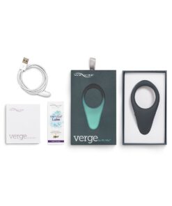 Slate colored We-Vibe Verge cock ring vibrator inside the box with charging cable, instruction manual and lube