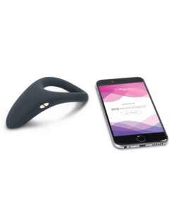 Slate colored We-Vibe Verge cock ring vibrator next to a phone showing the We Connect bluetooth app