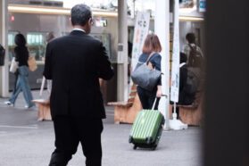 Woman carrying a suitcase through airport security