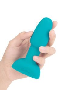 Hand holding the side of the Petite Teal B-Vibe Rimming plug