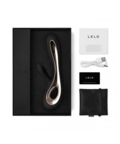 A black Lelo Soraya in a box next to the contents including the manual, usb cable, and lube