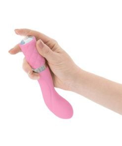 Hand pushing the button of a pink Pillow Talk Sassy g-spot vibrator