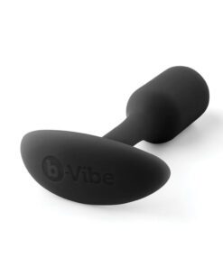 Small sized, black Snug Plug butt plug covered withÂ  silicone laying down on a white background