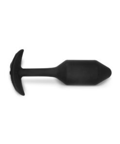 MediumÂ sized, vibrating, black Snug Plug butt plug covered withÂ  silicone laying on its side on a white background