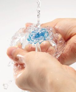 Water running down a Tenga Aero Cobalt Masterbater while hands clean them