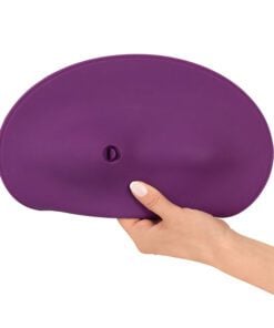 Hand holding the Vibepad 2, sit on vibrator