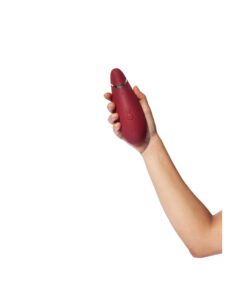 Hand holding a Bordeaux Womanizer Premium 2 Air Pulse Vibrator